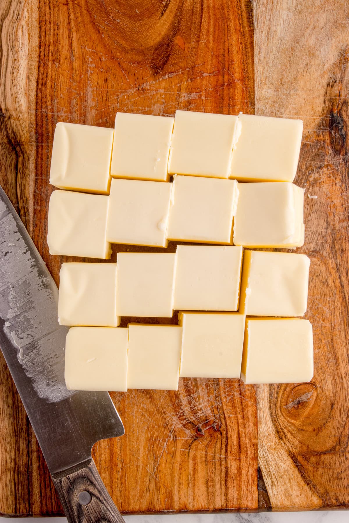 Cutting butter into cubes. 