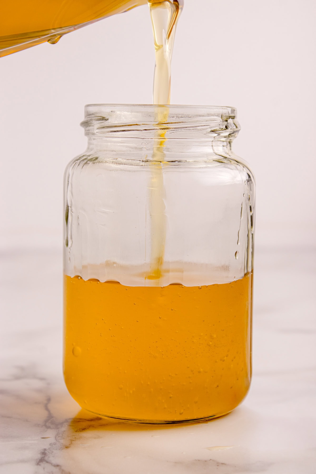 How to Make Ghee - pouring in a jar. 