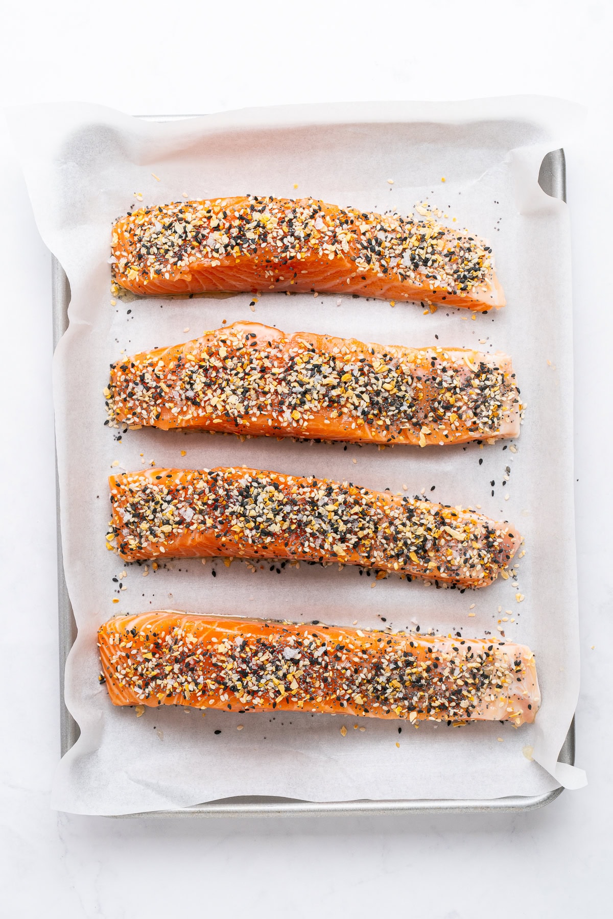 Salmon fillets on a sheet pan.