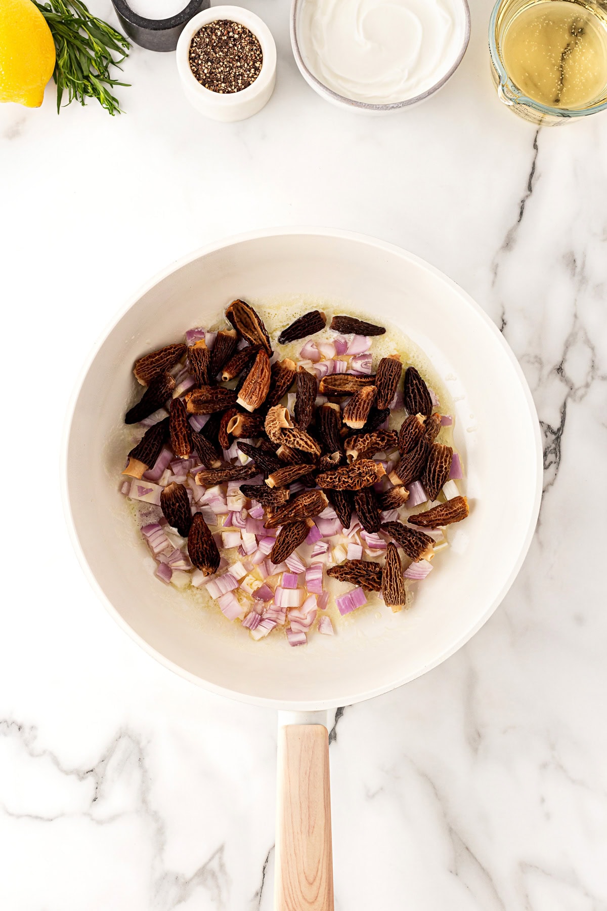 Morels, shallots and butter in a pan. 