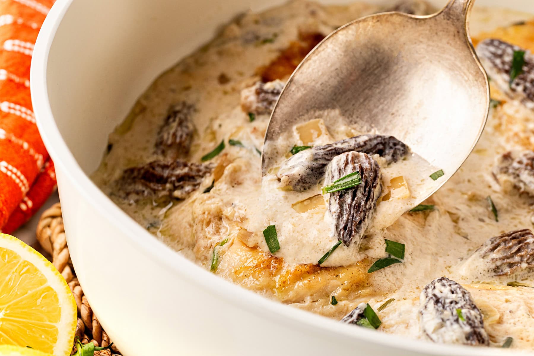 Spooning morels over chicken. 