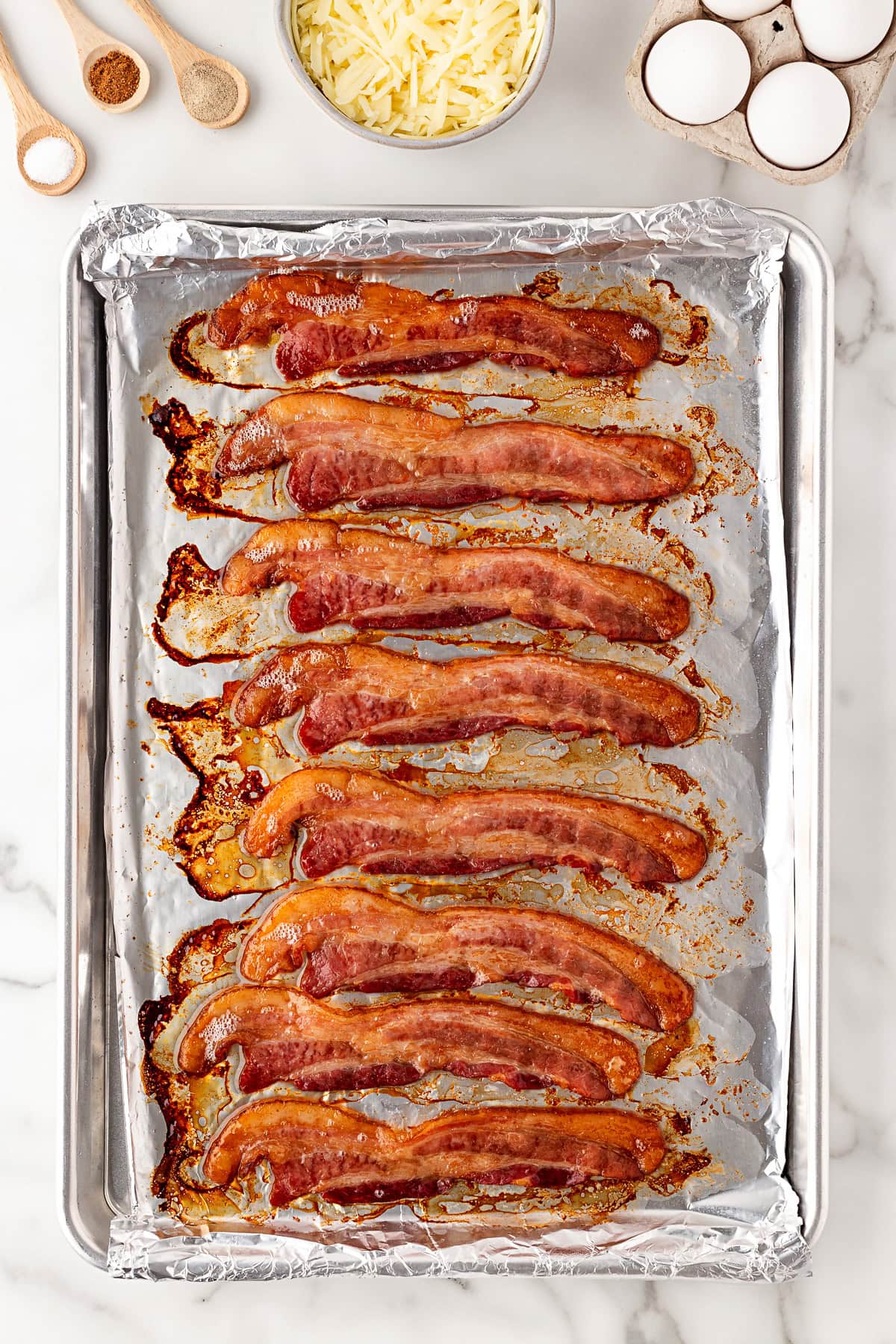 Cooked bacon on baking sheet.