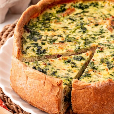First slice being taken from a Deep Dish Quiche.