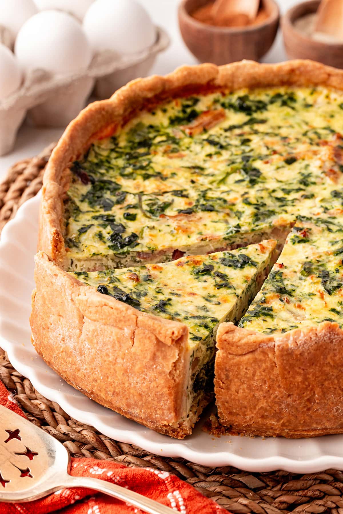 One slice being taken from a Deep Dish Quiche. 