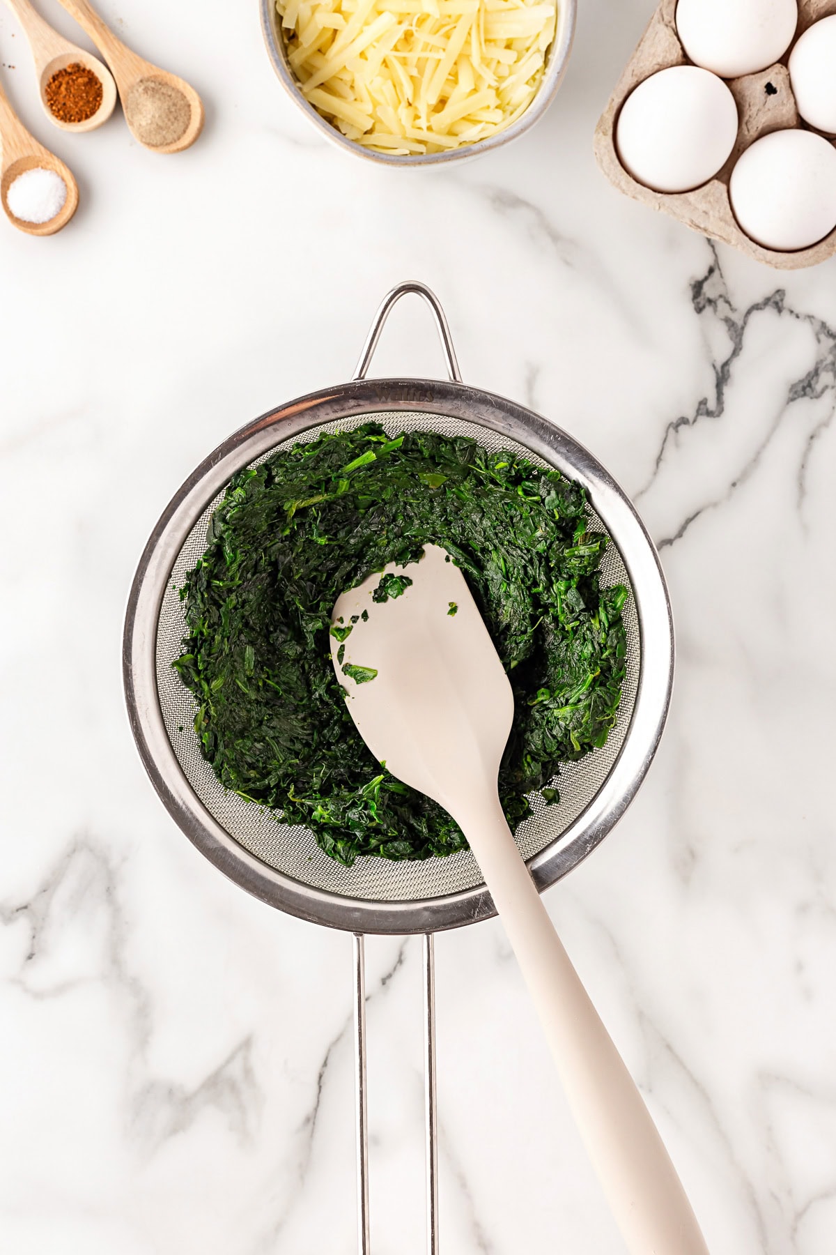 Frozen spinach in a sieve. 