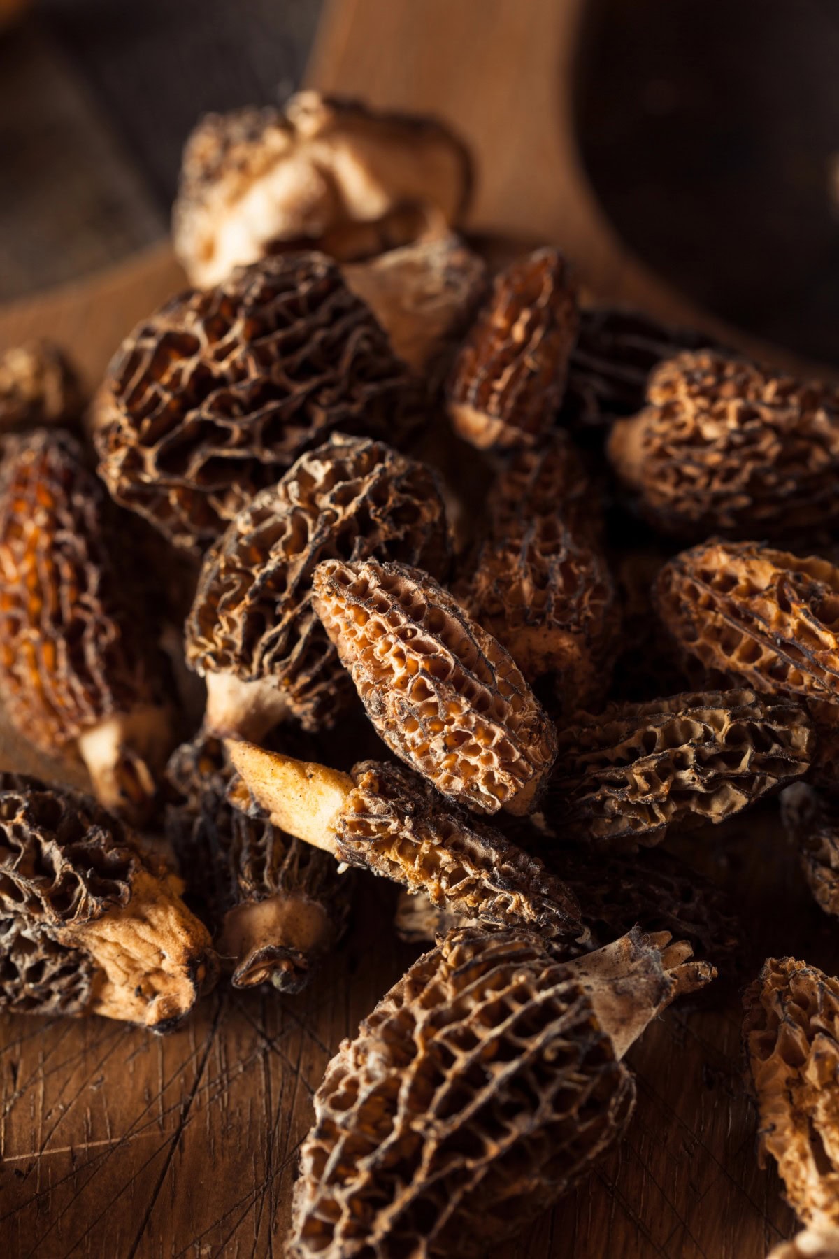 Morel mushrooms on a cutting board.