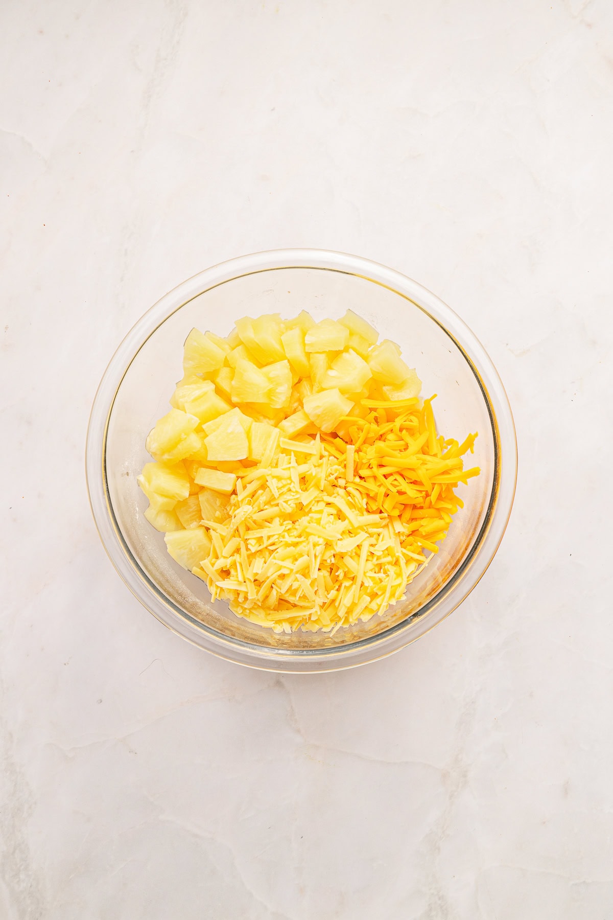 Mixing pineapple and cheese blend.