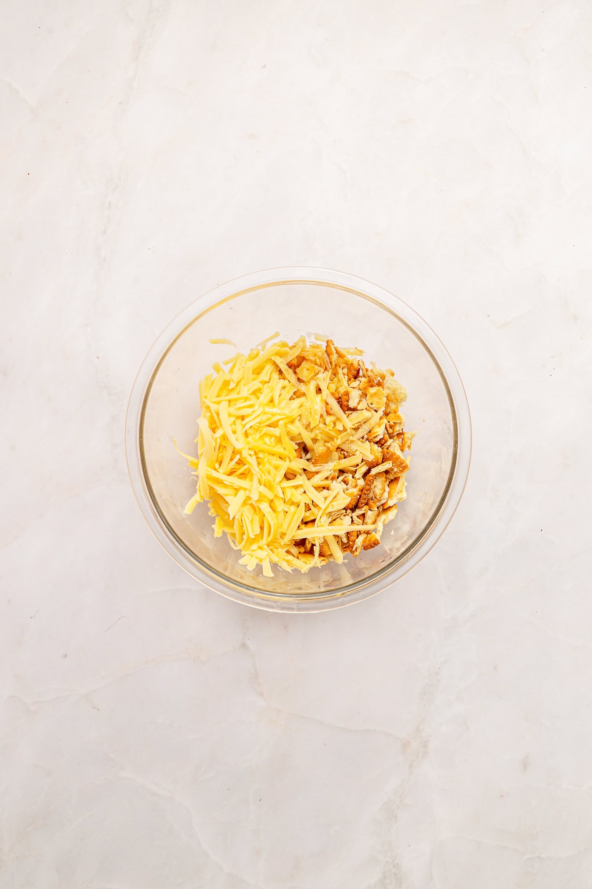 Adding shredded cheddar.