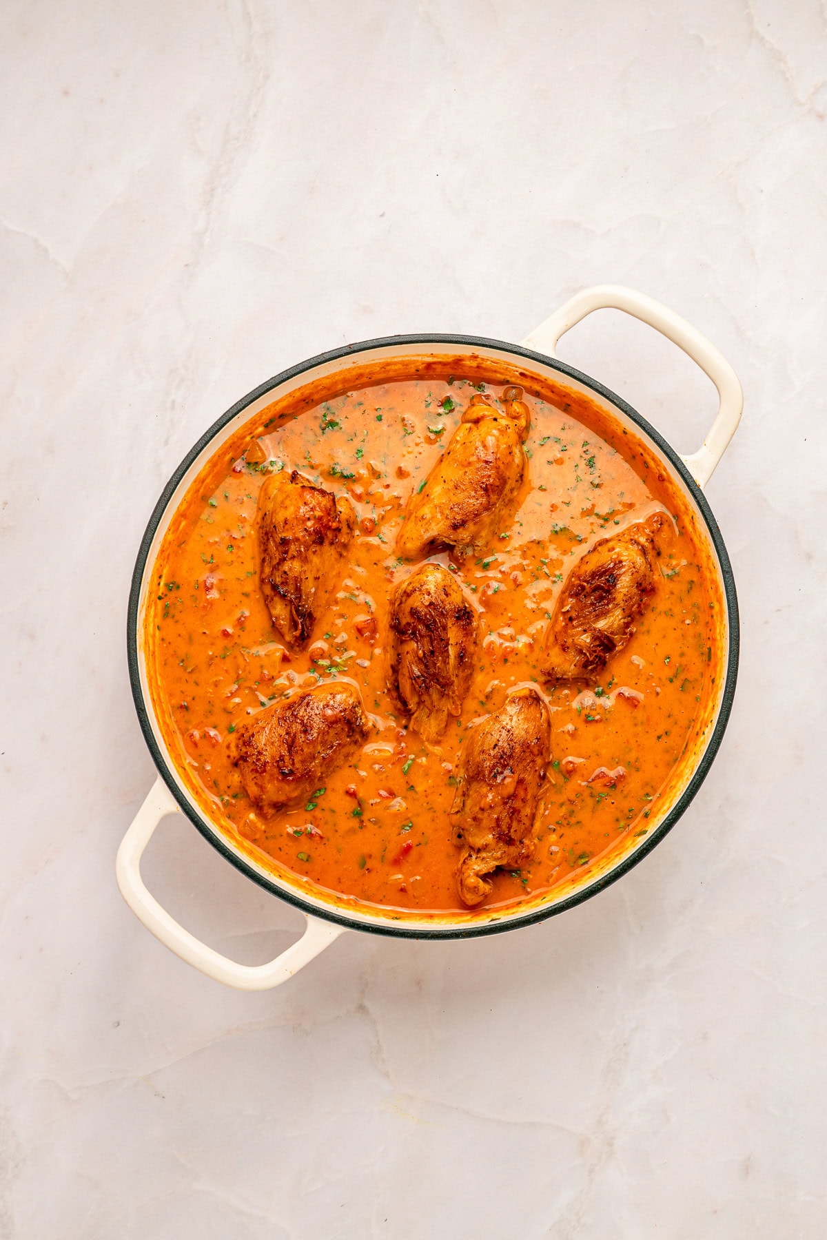 Stirring cilantro into the sauce.