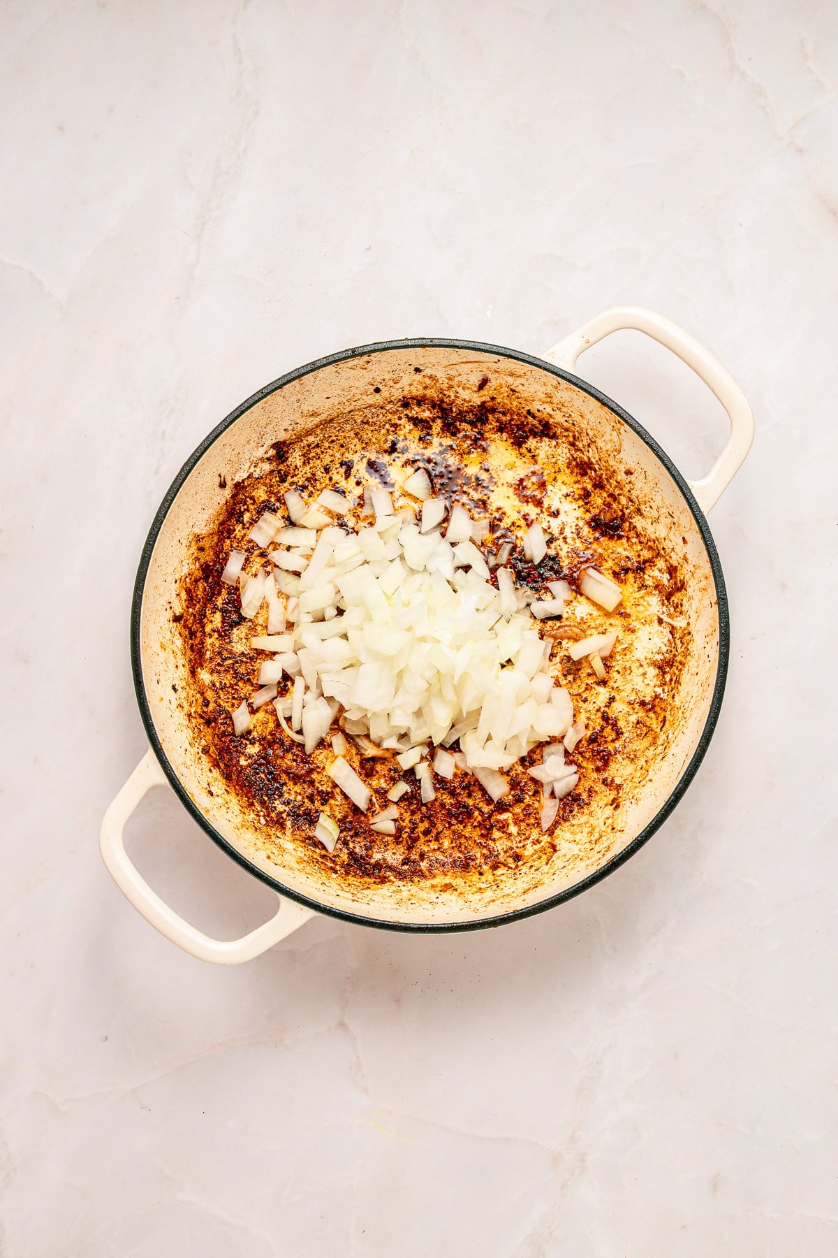 Saut&eacute;ing onions in a skillet.