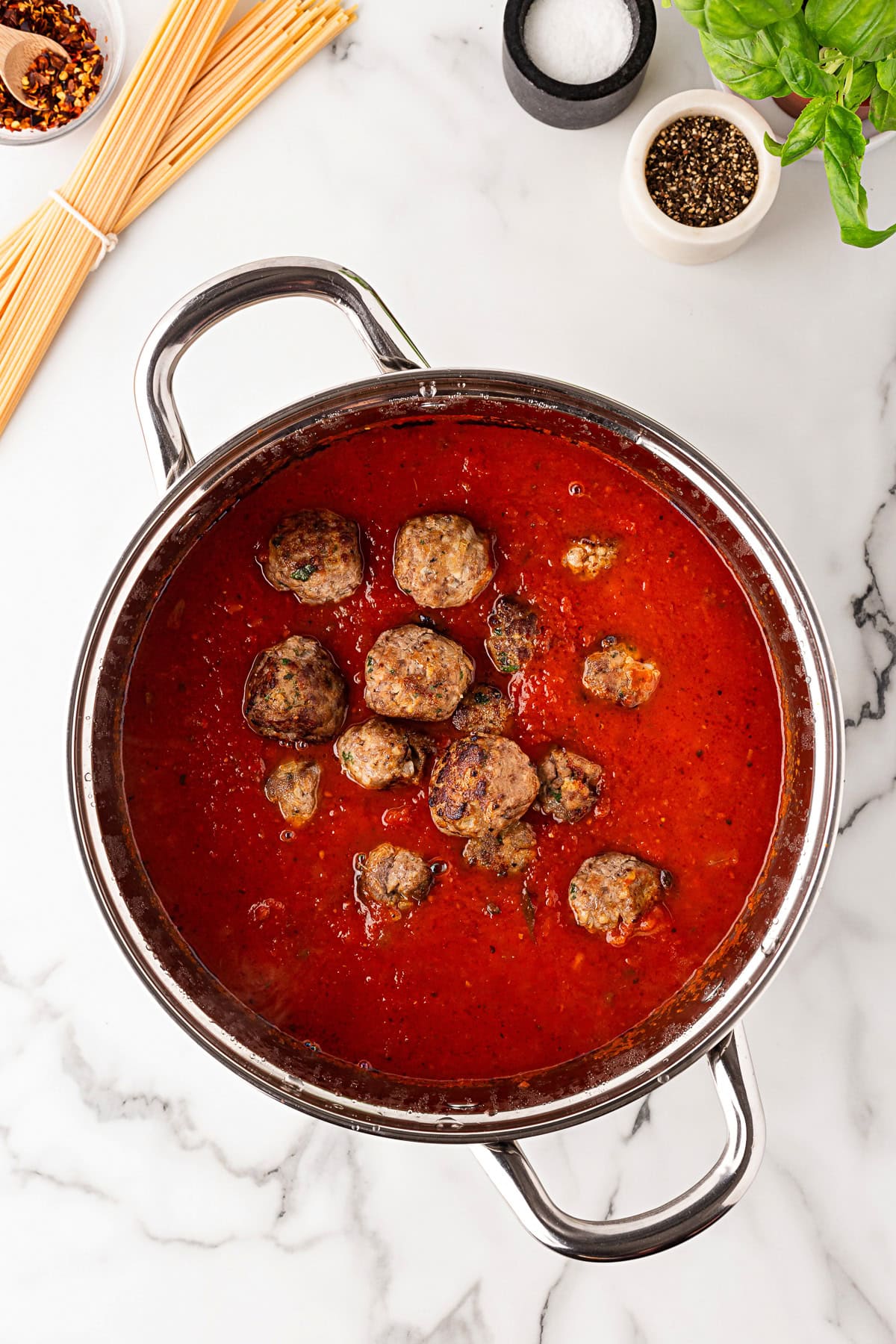 Meatballs added to sauce. 