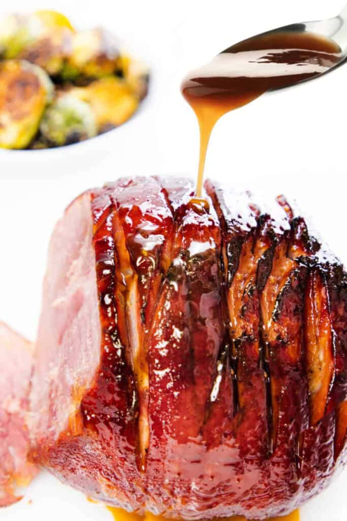 Honey being poured on ham.