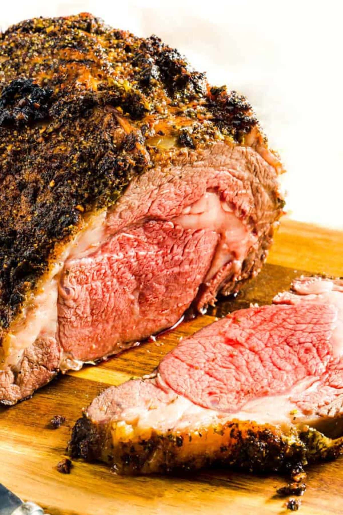 Prime rib on wooden cutting board.