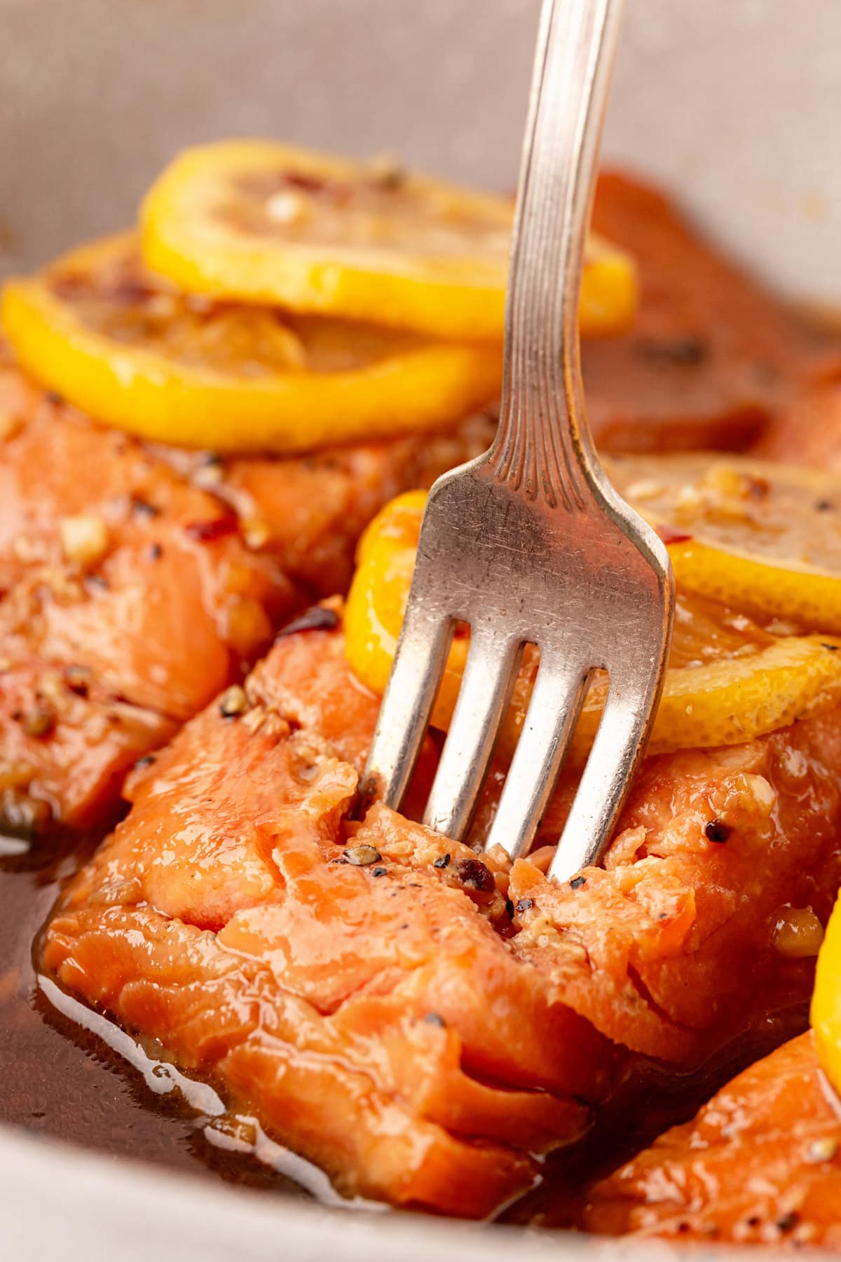 Piercing the trout with a fork. 