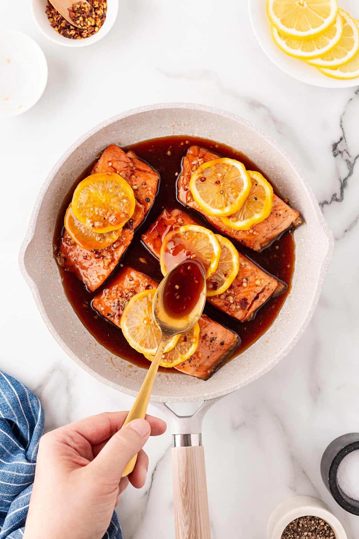 Spooning sauce over the trout. 