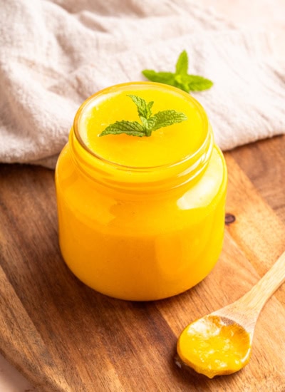 Overhead lemon curd in a jar.