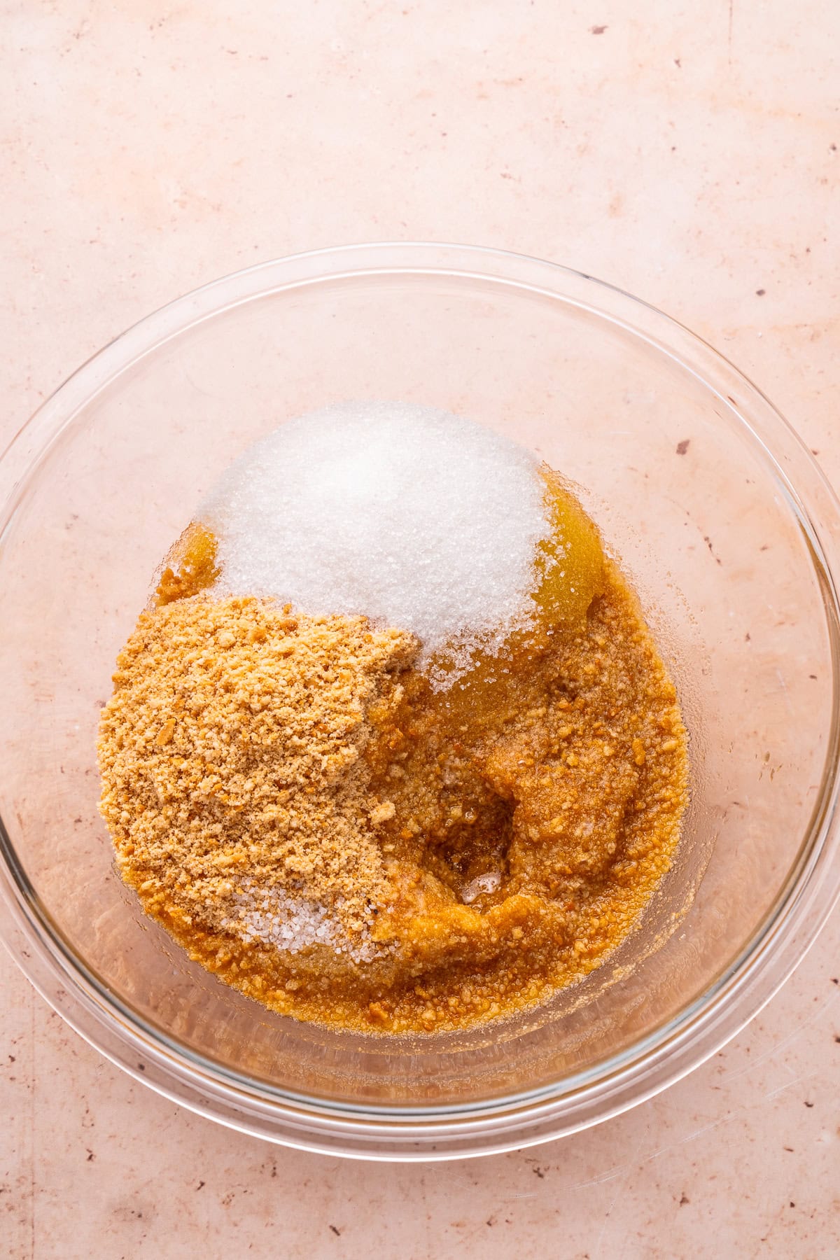 Mixing cheesecake crust ingredients.