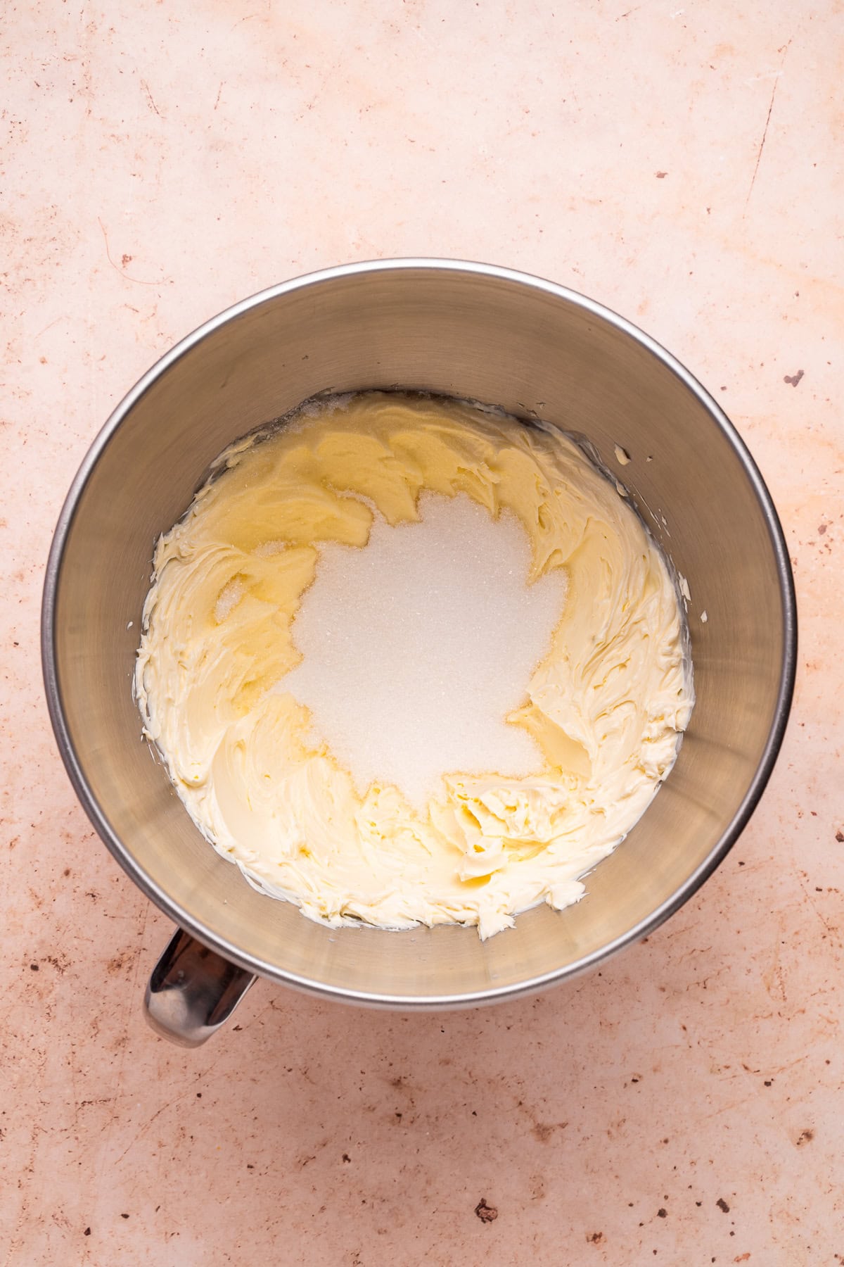 Beating cream cheese with sugar.