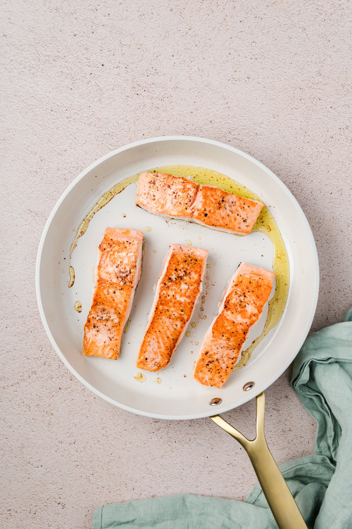 Salmon flipped over in pan. 