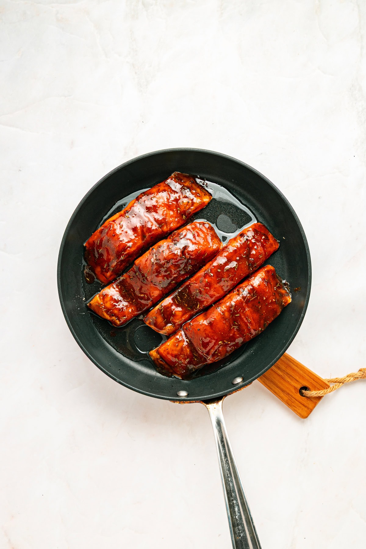Searing salmon fillets in a hot skillet.