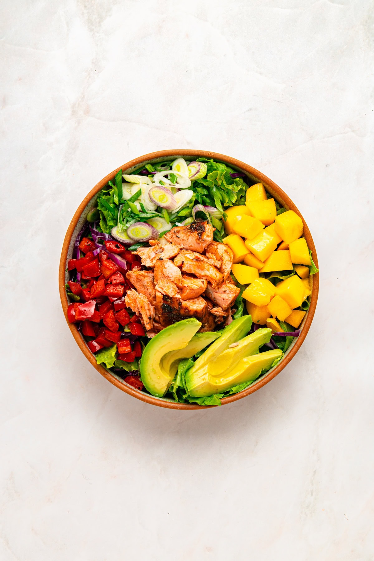 Salmon cobb salad assembly.