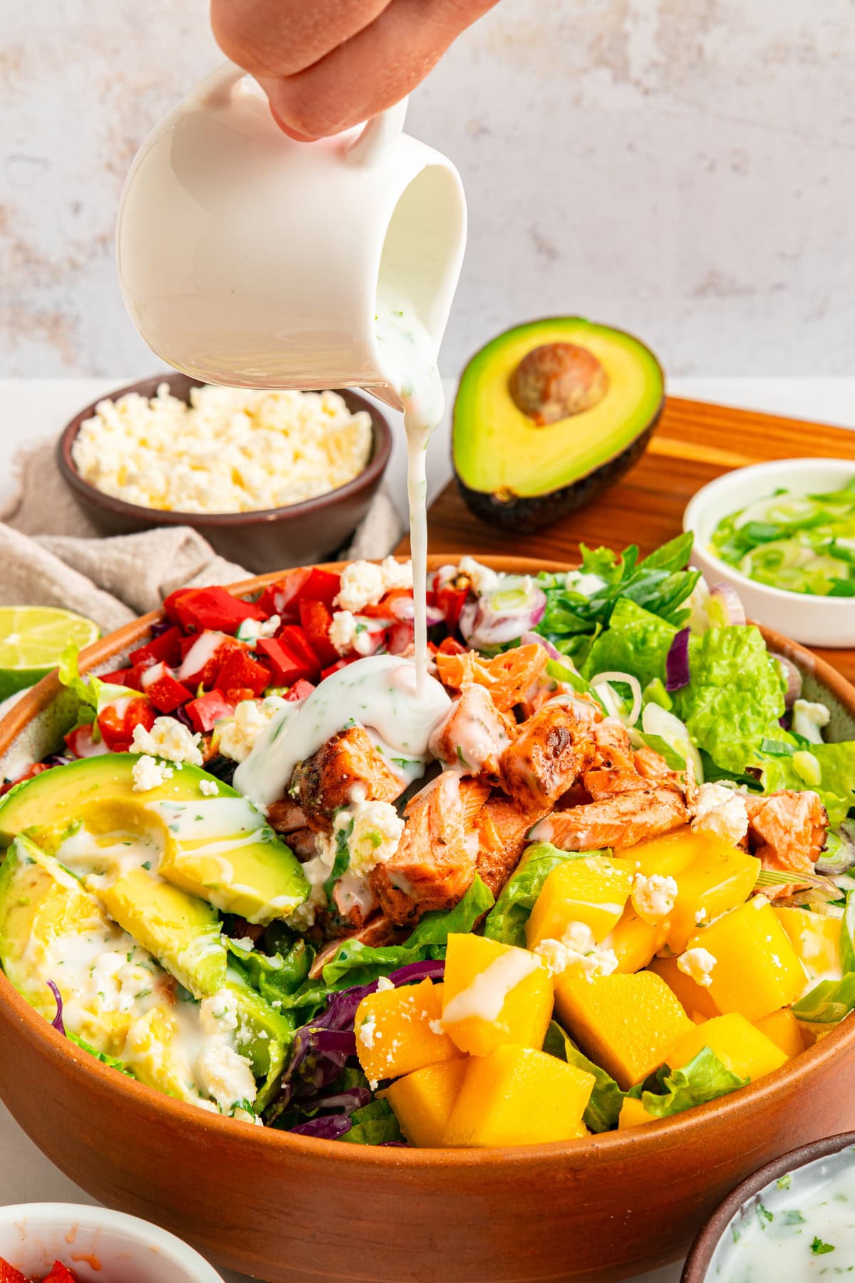 Pouring coconut cilantro dressing.