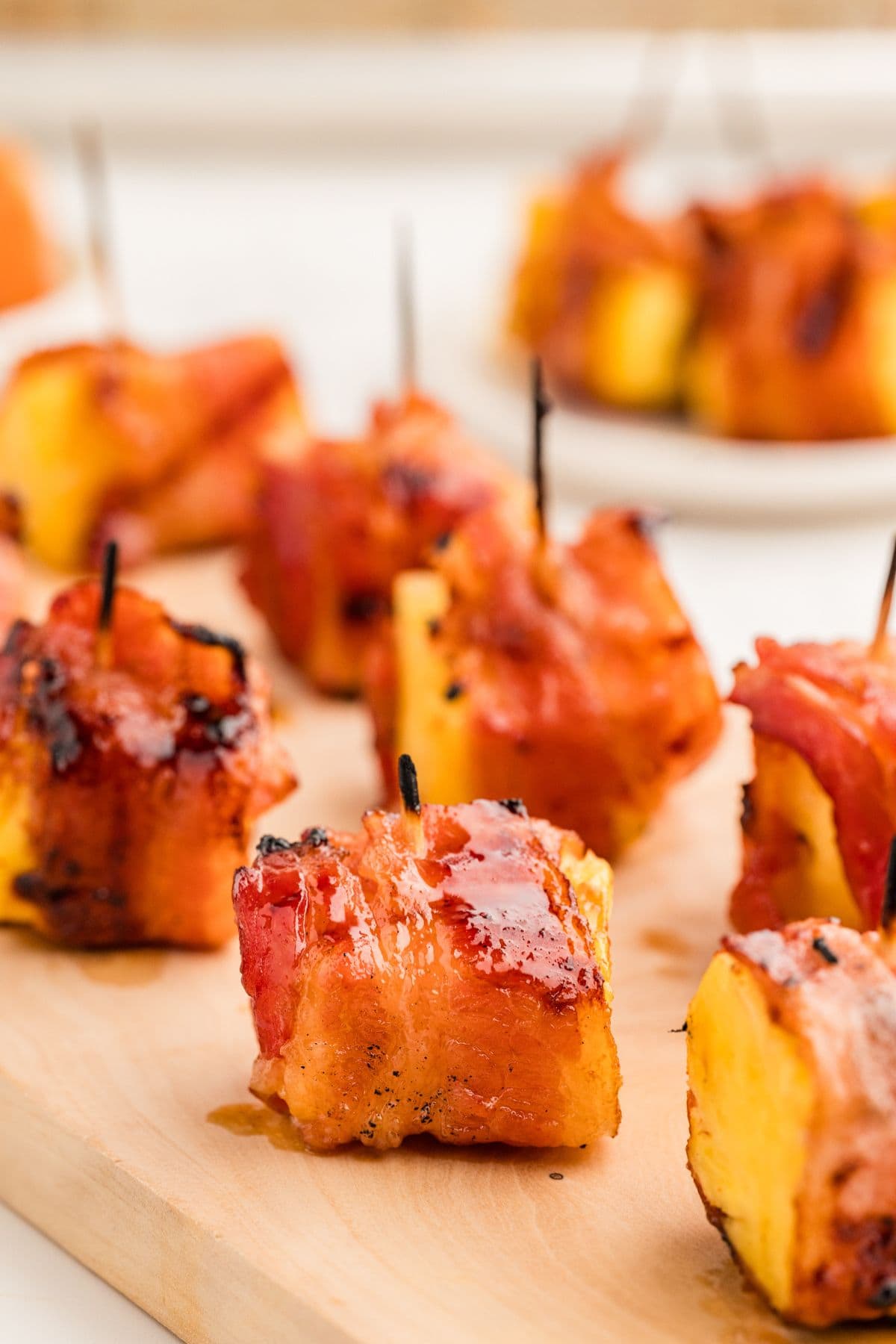 Pineapple bites on wooden cutting board.