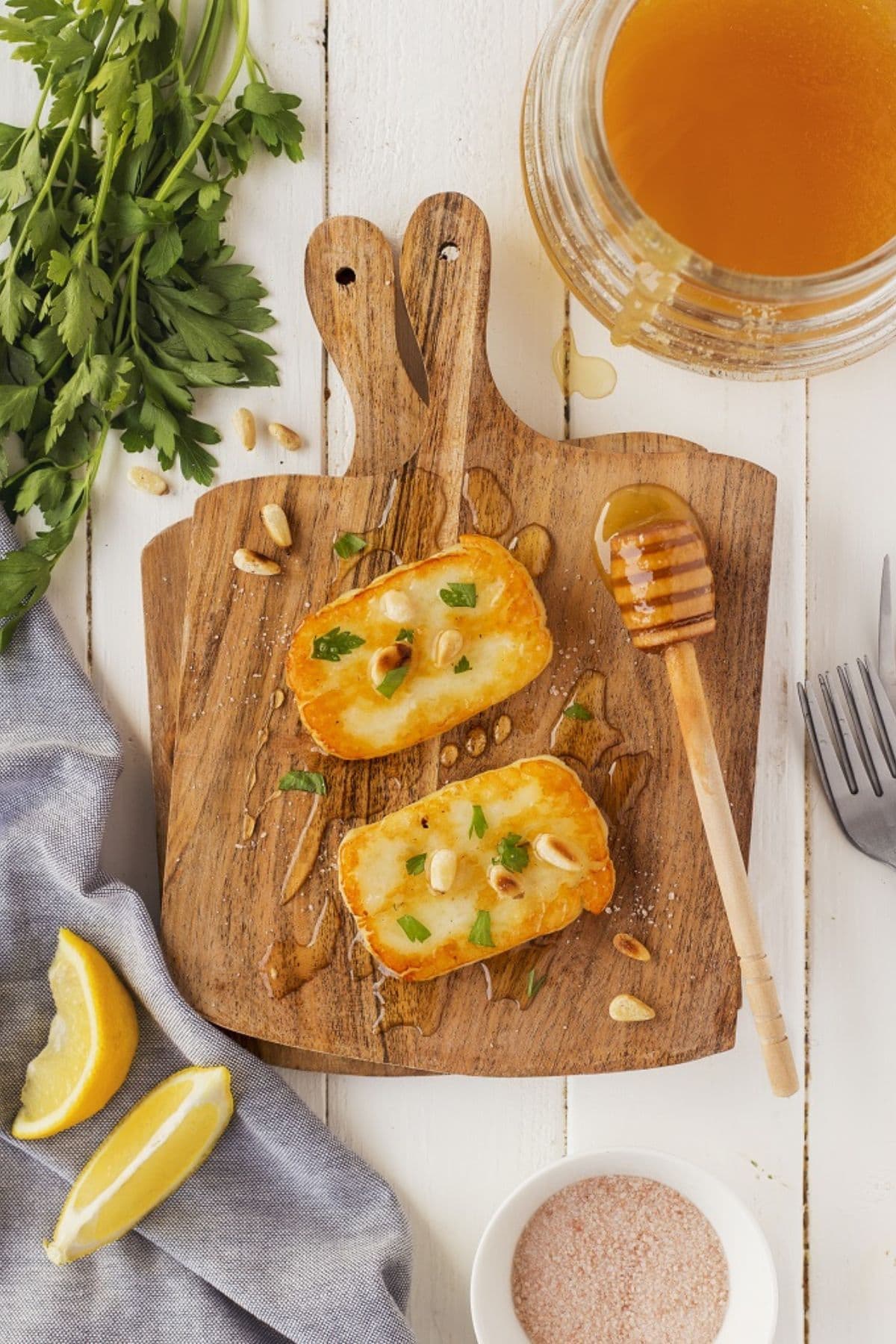 Fried cheese on a wooden cutting board.