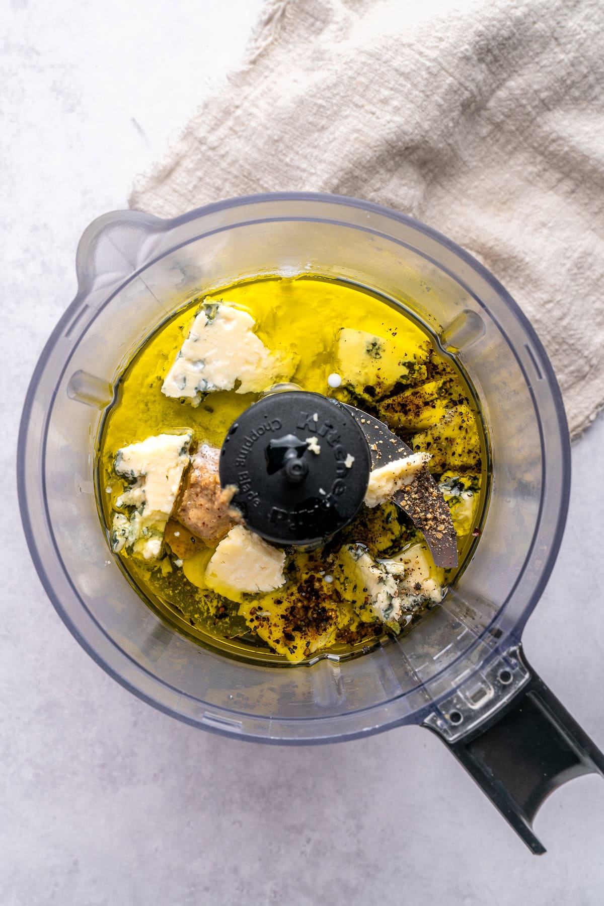 Blue cheese dressing ingredients in a food processor.
