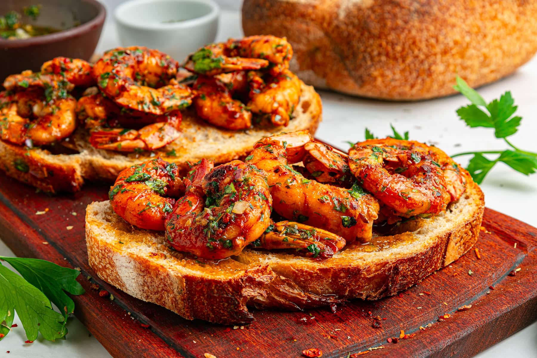 Chimichurri shrimp served with crusty bread.