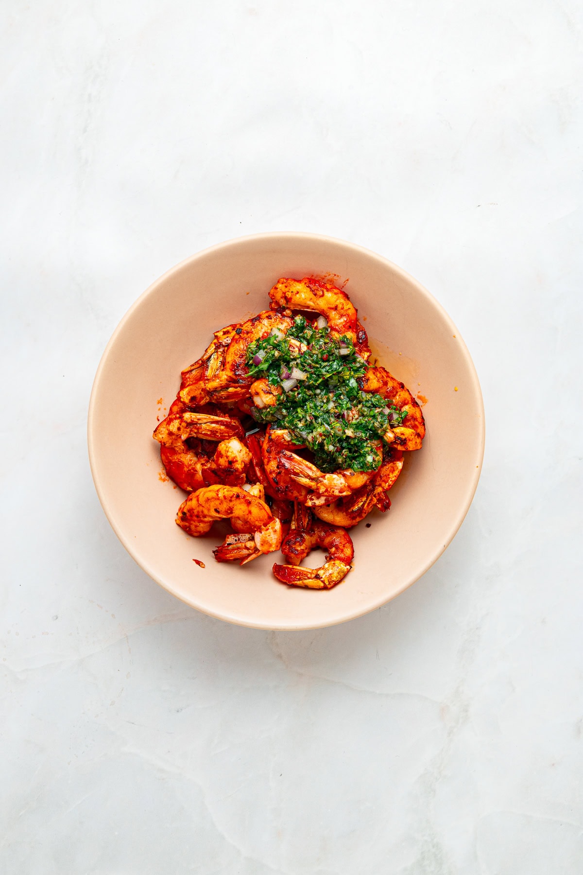 Tossing shrimp with chimichurri.