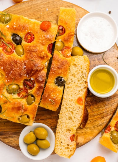 Overhead of focaccia with some sliced.