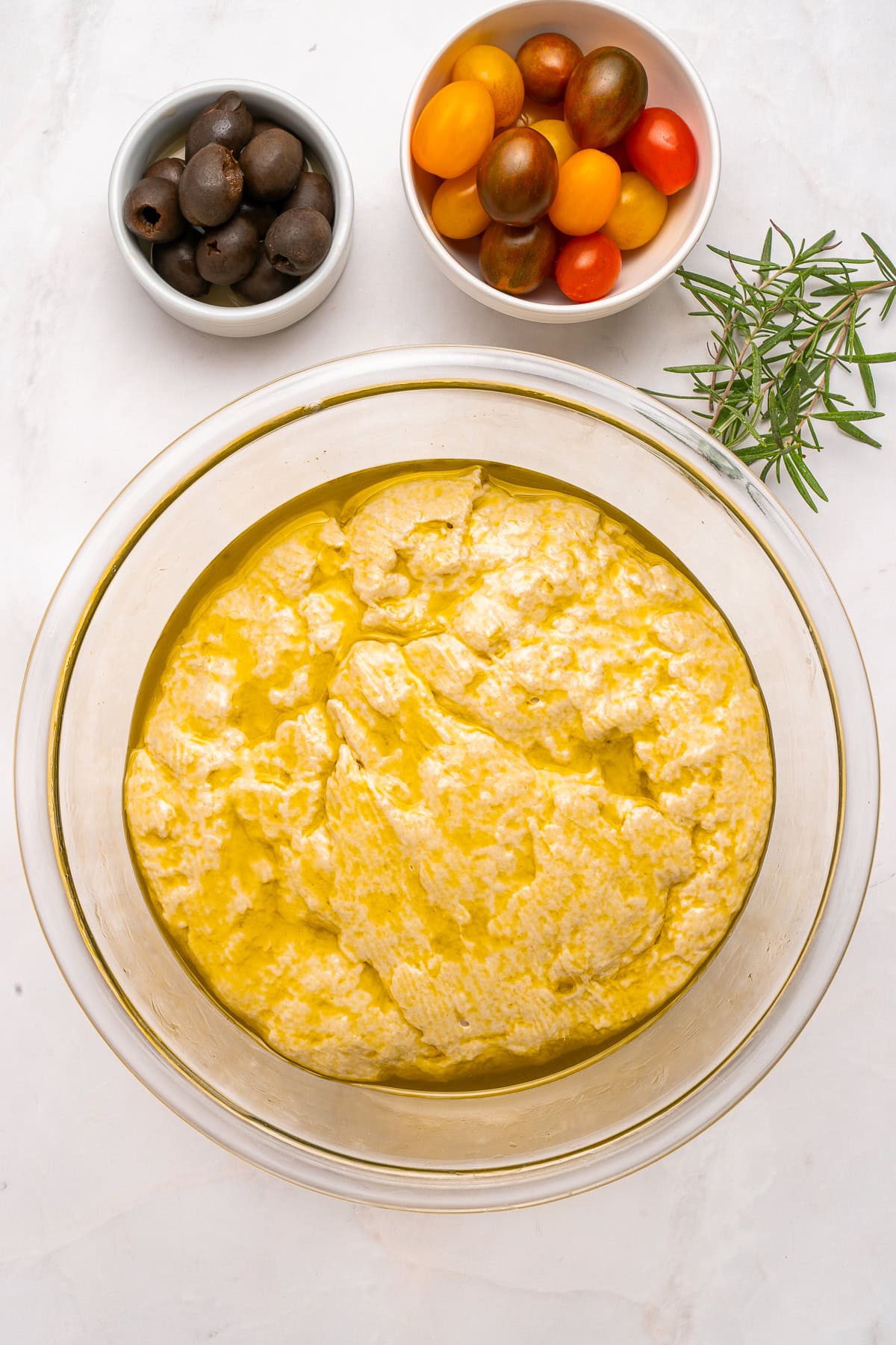 Coating dough with olive oil.