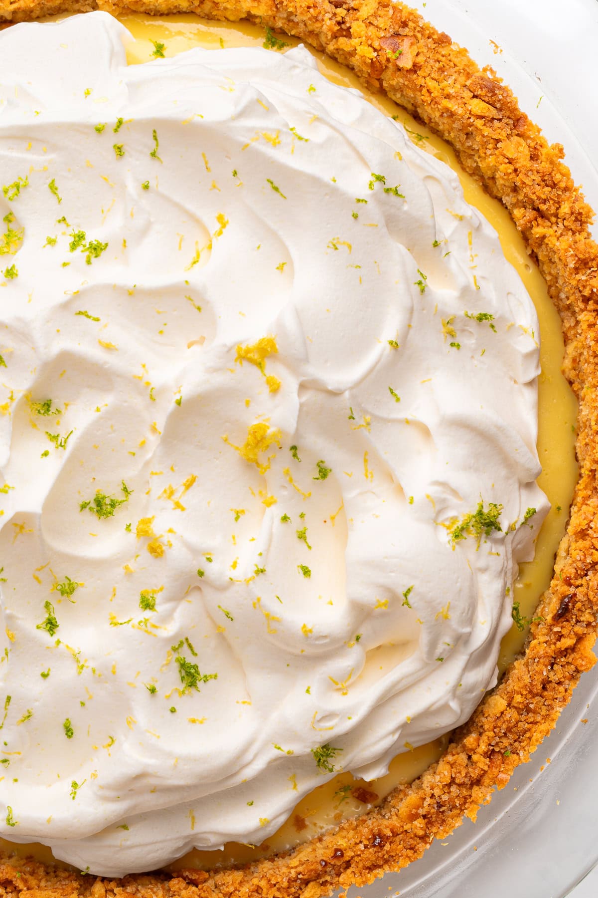 Pie topped with whipped cream, close-up.