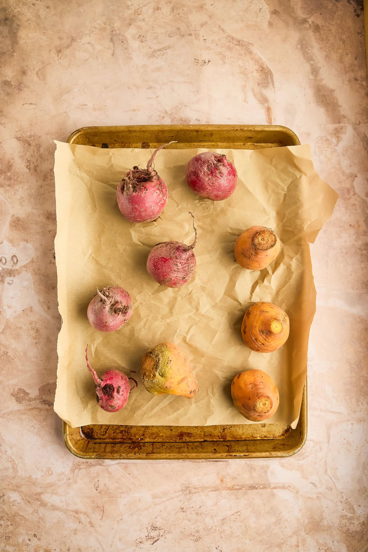 Whole beets on baking sheet.