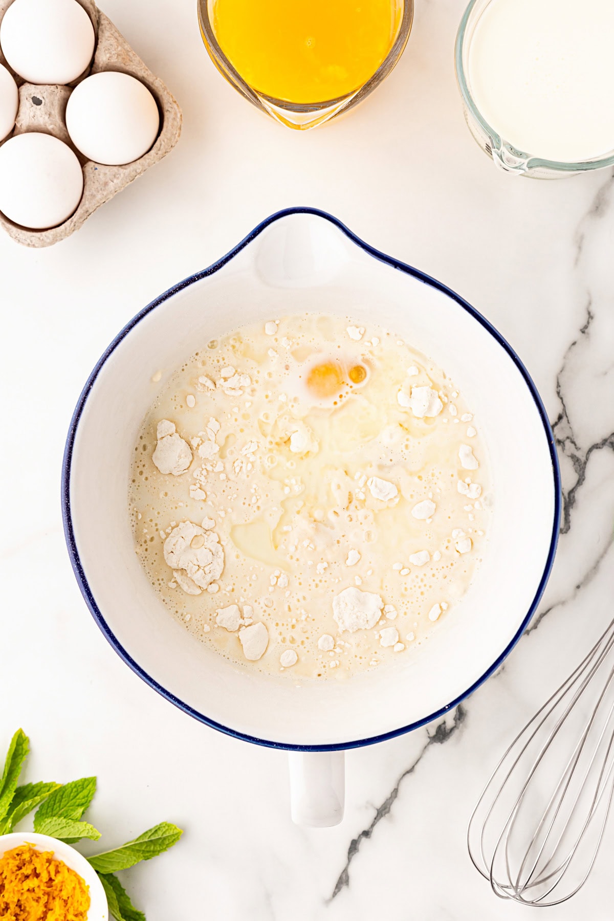 Crepes batter ingredients in a bowl.