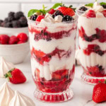 Eton Mess in glasses with berries in the background.