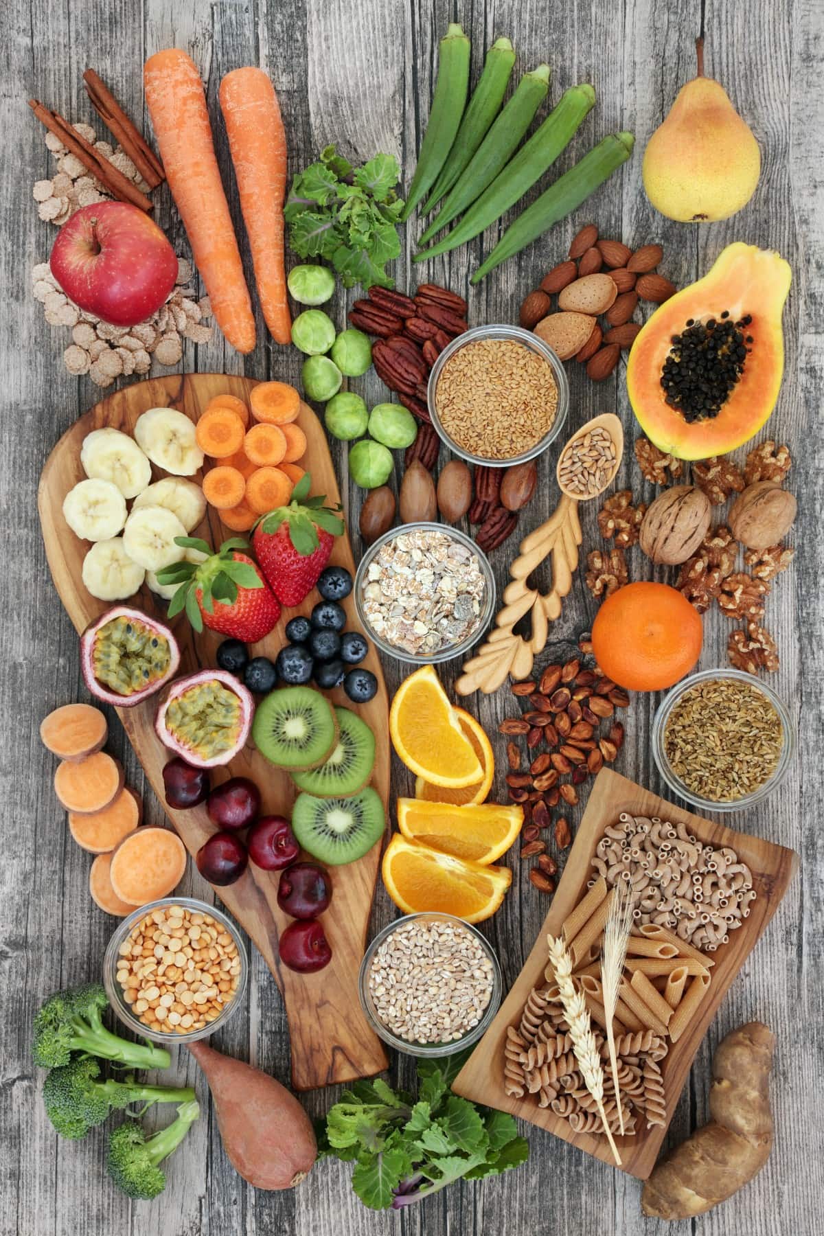 Foods high in fiber from overhead on a wood background..