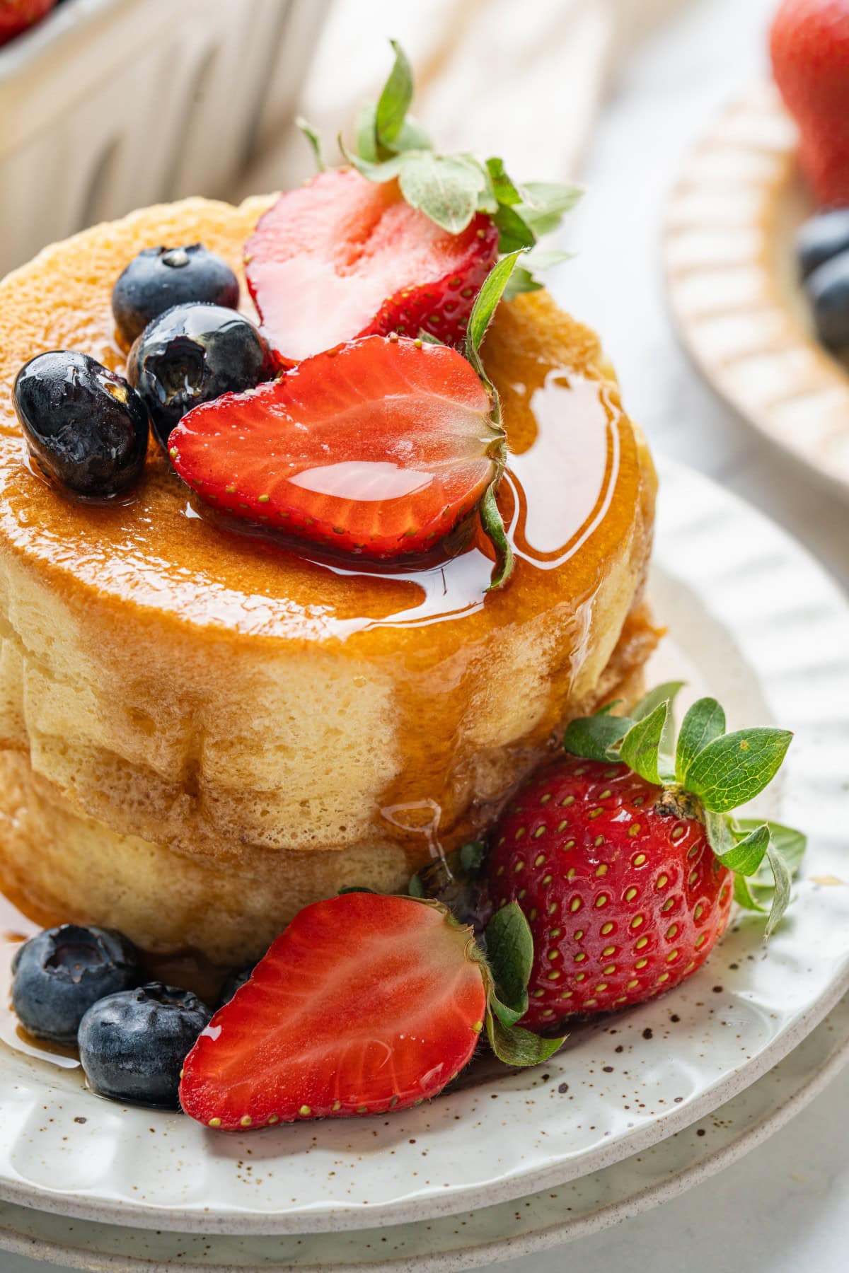 Japanese Soufflé Pancakes with berries and syrup.