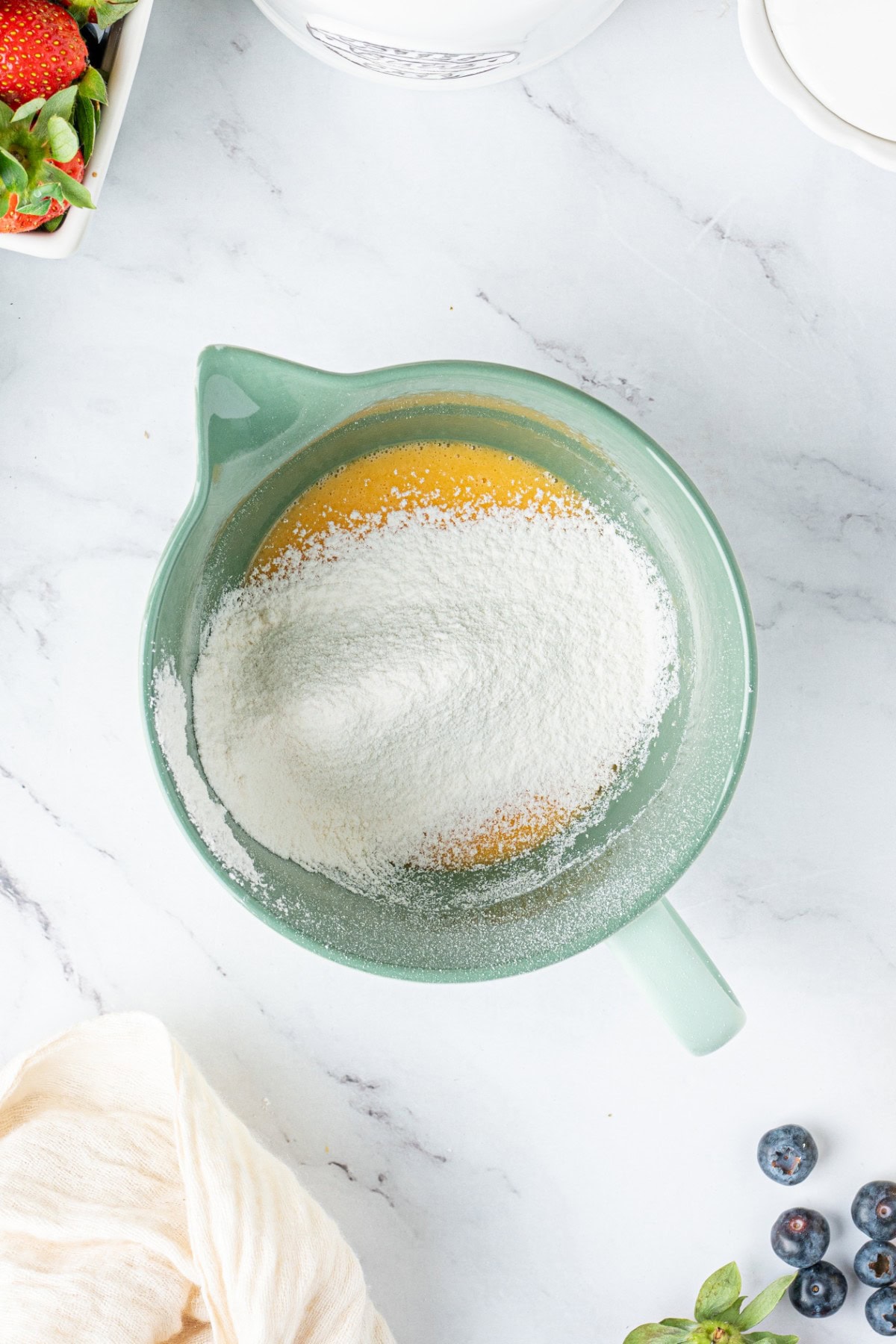 Adding flour to yolk mixture.