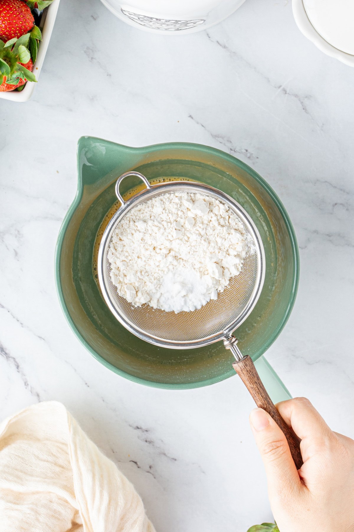 Sifting flour.