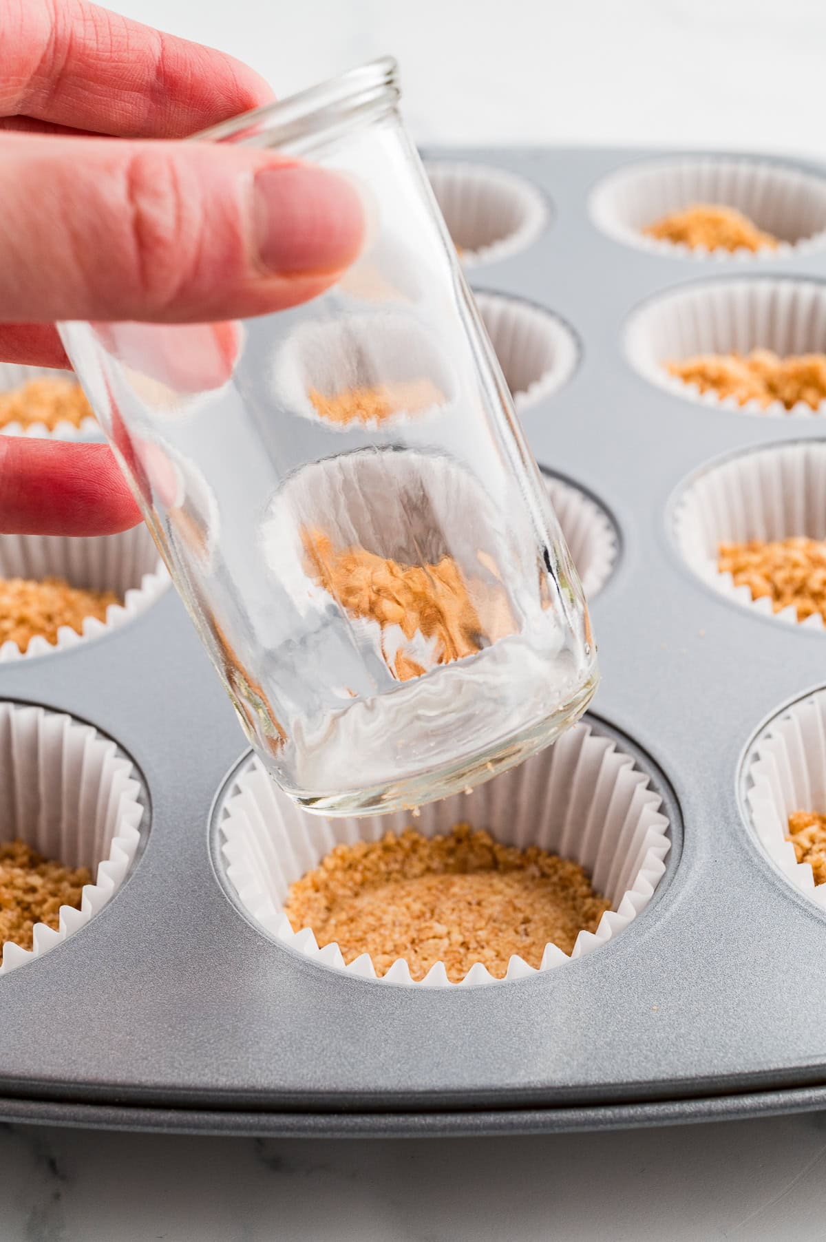 Pressing down the waffle cone mixture. 