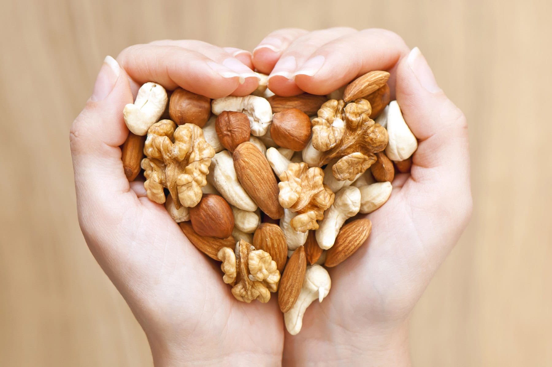 Two hands holding nuts.