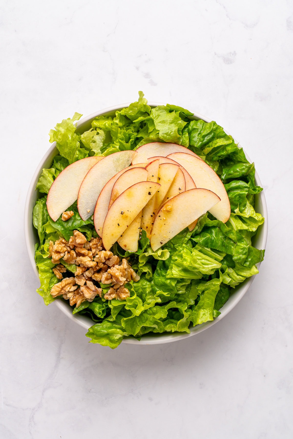 Mixing salad ingredients.