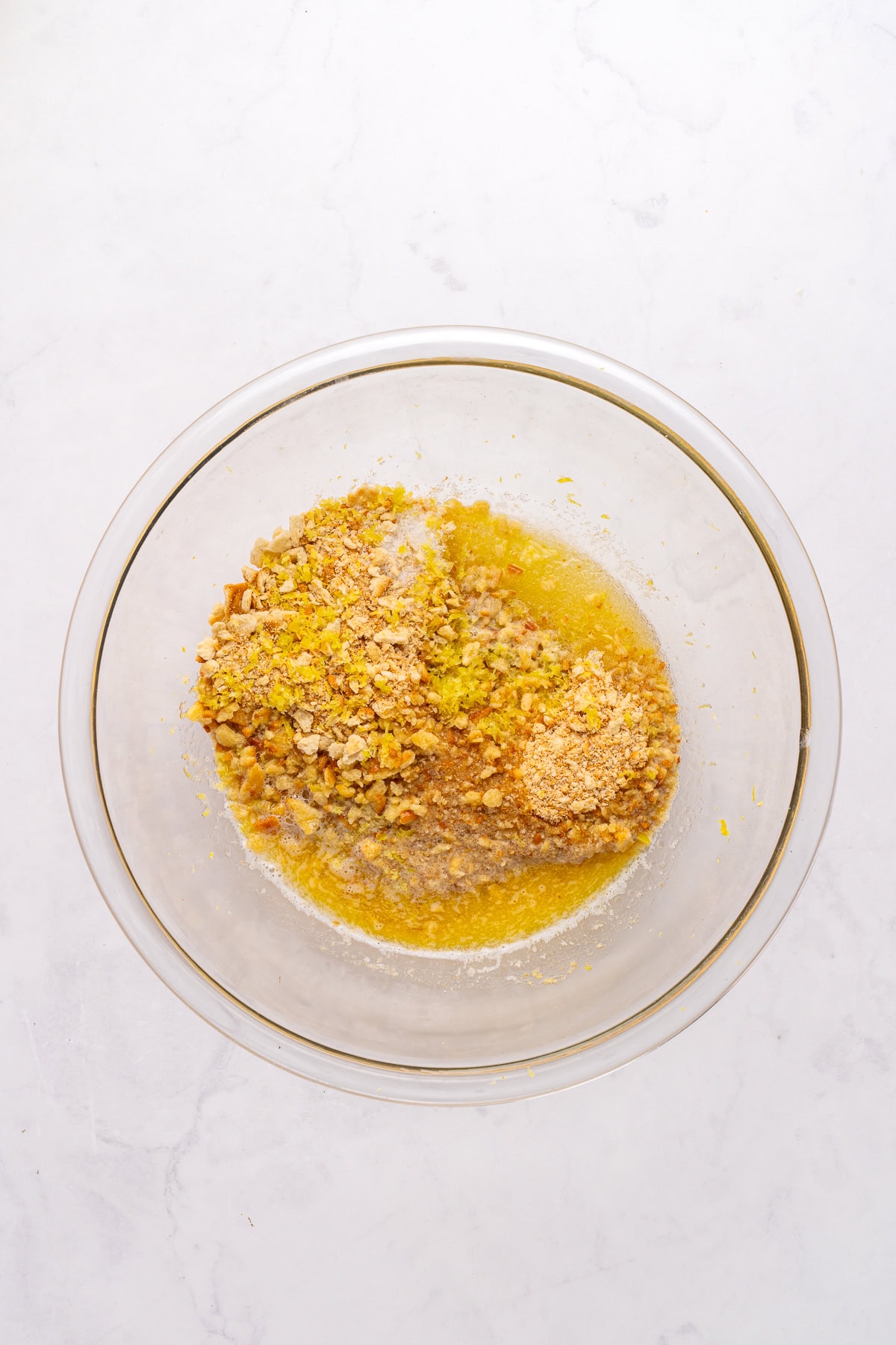 Mixing crushed crackers with melted butter and sugar.