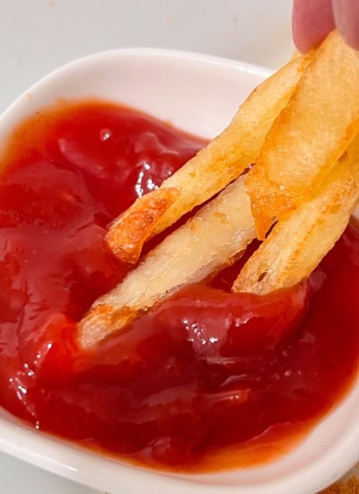 Dipping in ketchup.