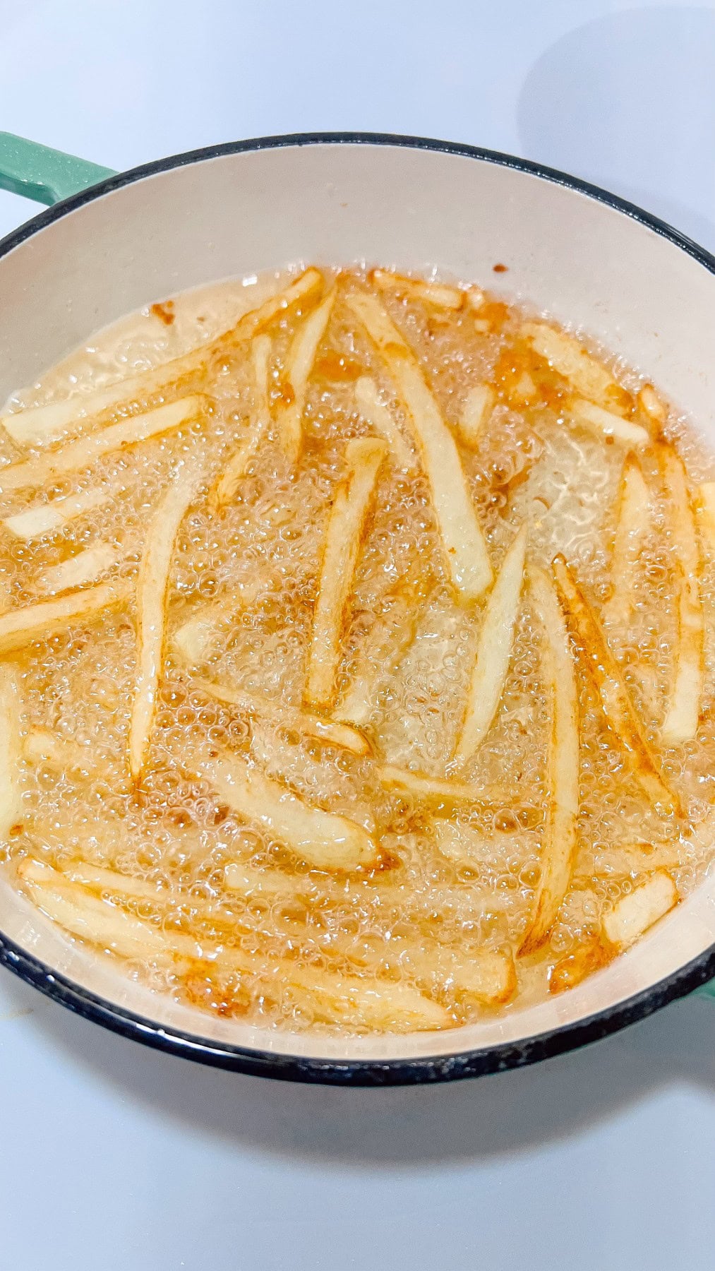 Fries turning golden brown in oil. 