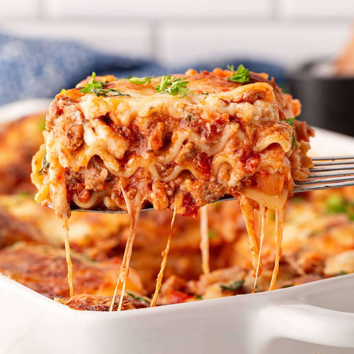 Taking out a slice of lasagna.