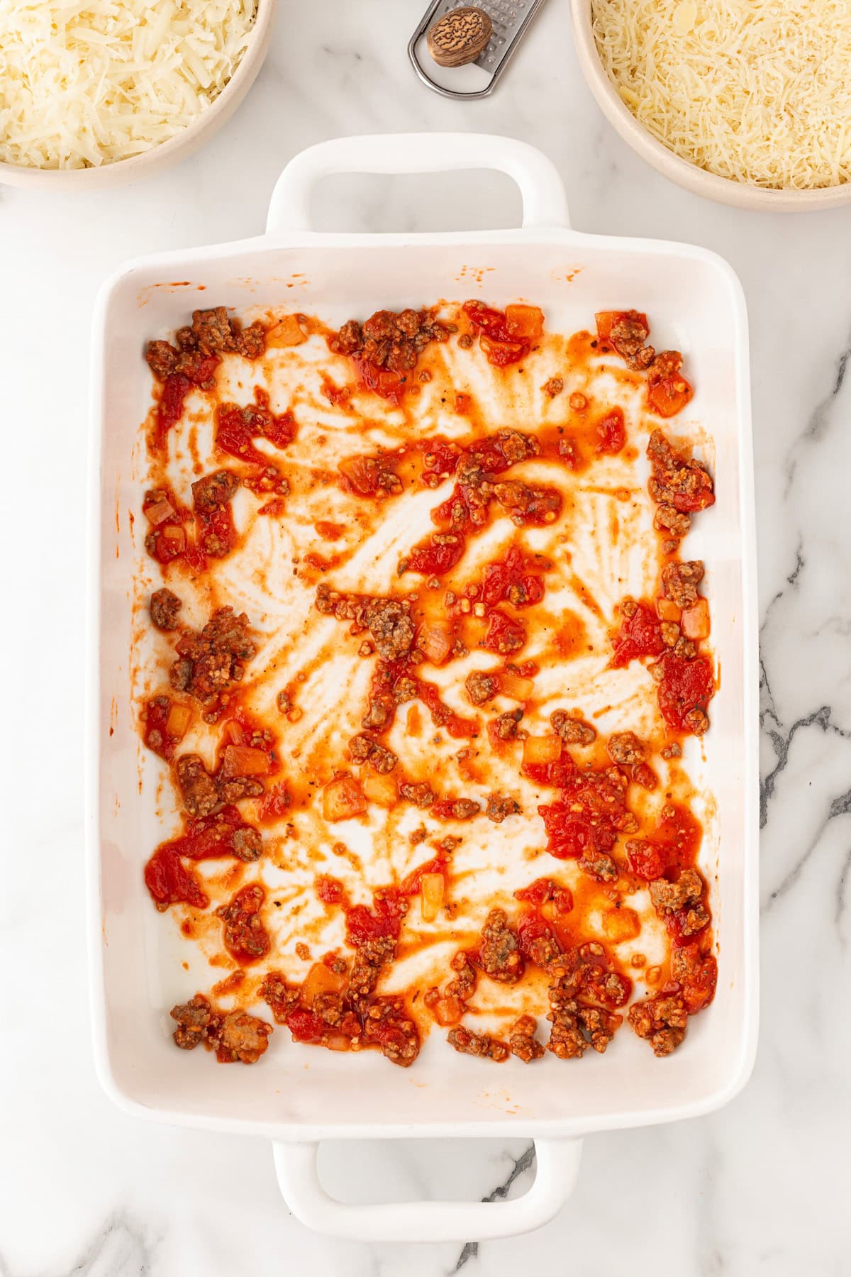 Starting to build the lasagna, small amount of meat added.