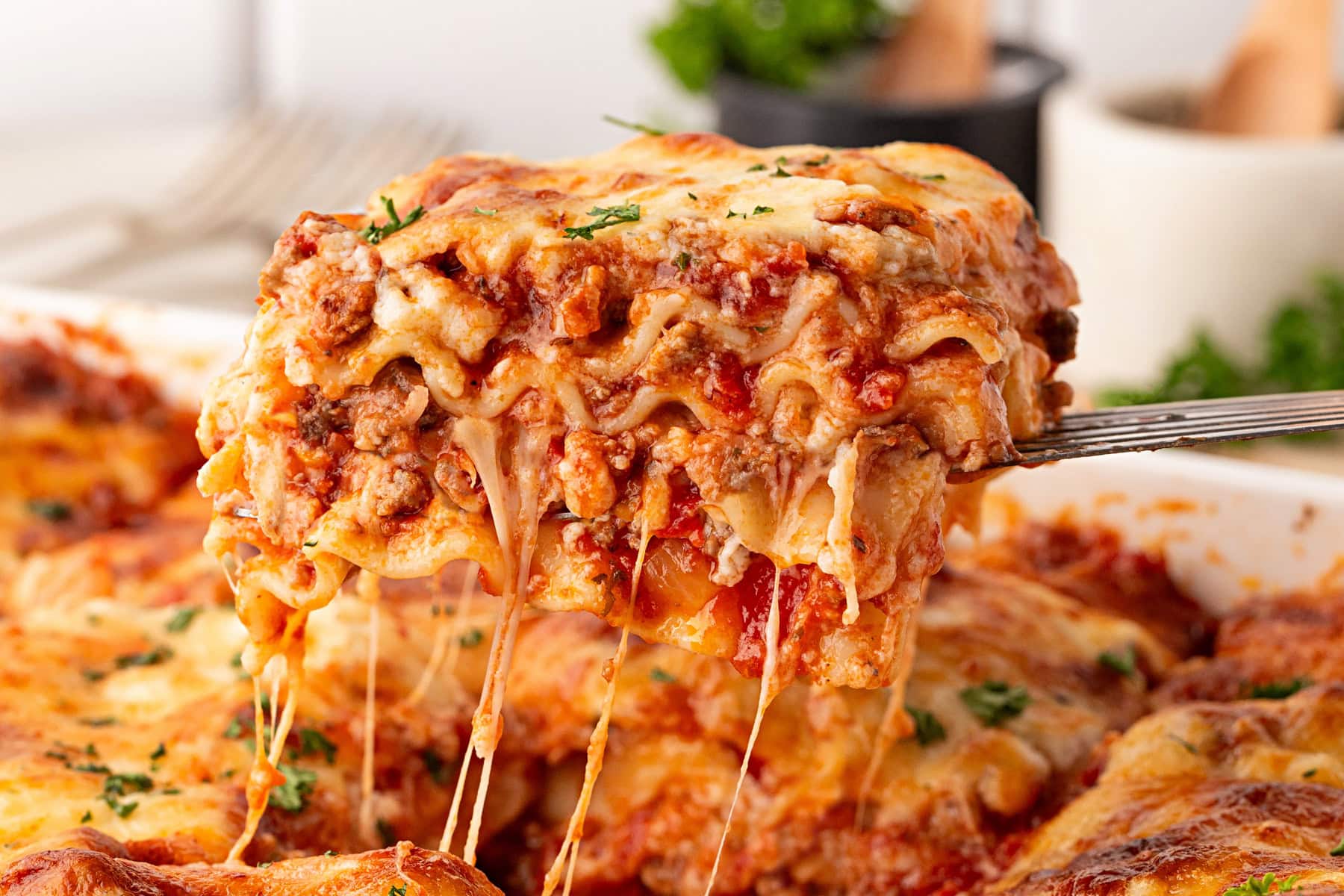 Taking out a slice of lasagna.